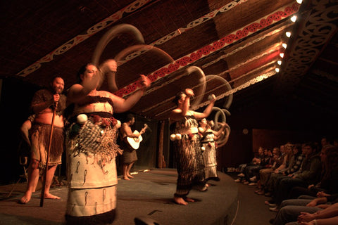 A group of kapa haka performers spinning traditional Maori poi