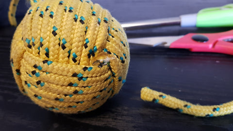 A close up of a monkey fist showing how to melt it to make a DIY rope dart