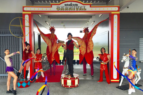 A group of performers pose with their fire props and hula hoops