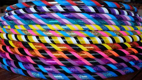 A large stack of bright and bold hula hoops