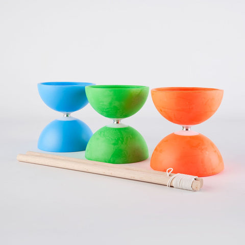 Three brightly coloured diabolo sit against a light backdrop