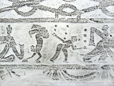 An ancient carving depicting a person juggling with juggling balls