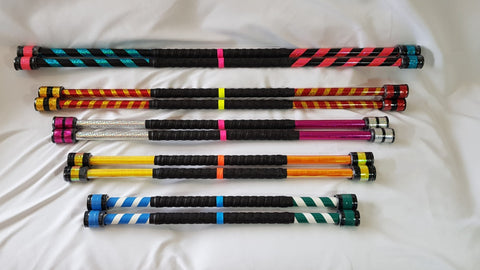 Five sets of varying sized double staff sit on a white backdrop