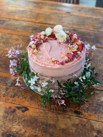 Cake topped with flowers and berries 