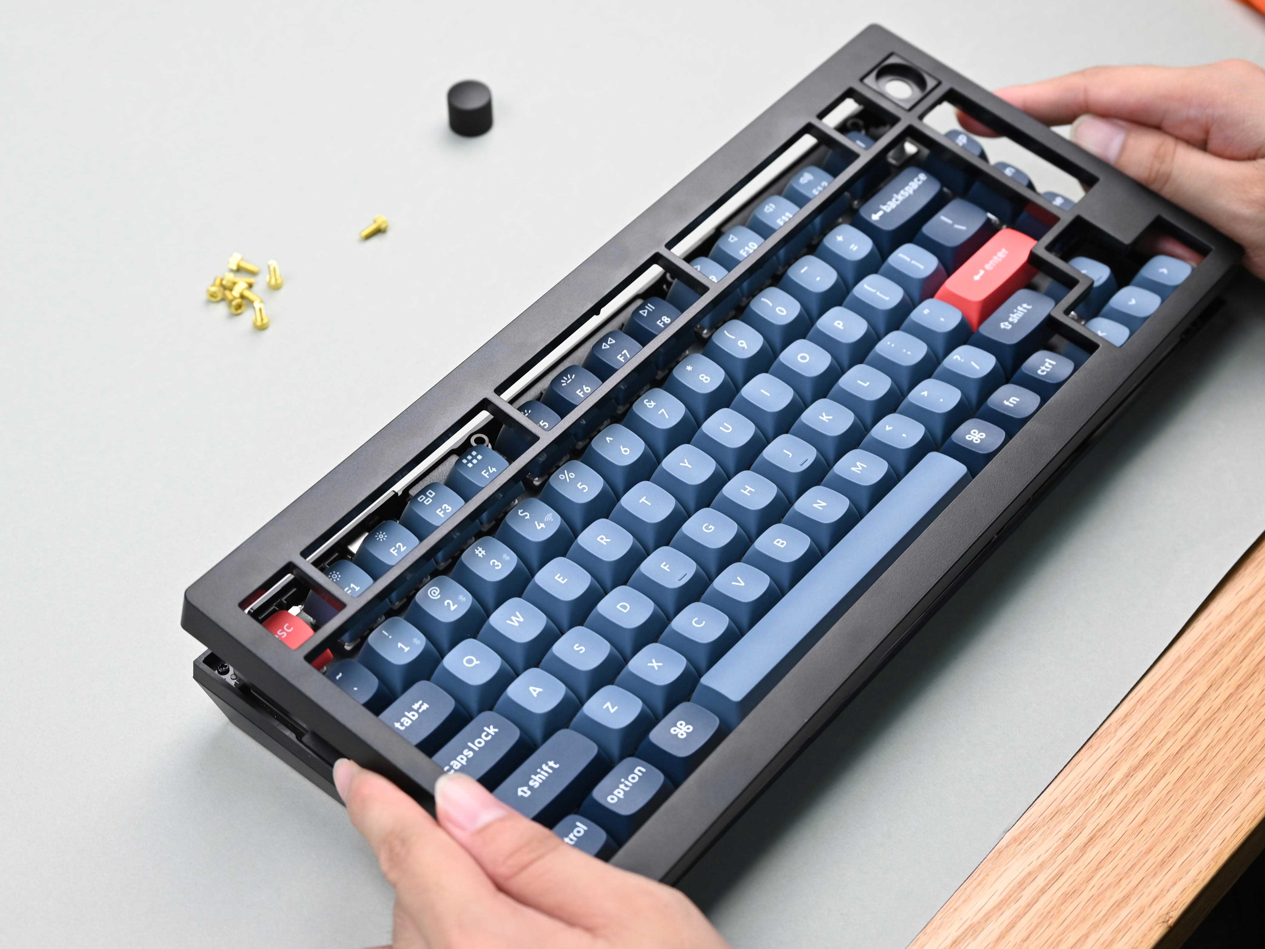 Using the hex key, unscrew the screws from the back of the keyboard 