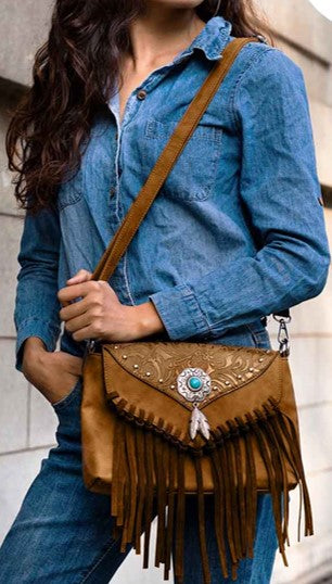 woman in denim outfit with brown vegan leather shoulder bag with tassels and turquoise concho from Montipi