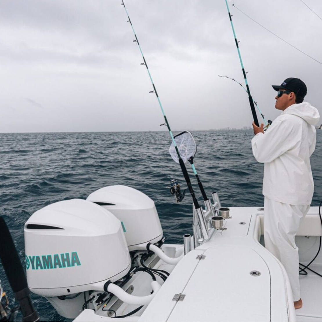 Man fishing from back of boat