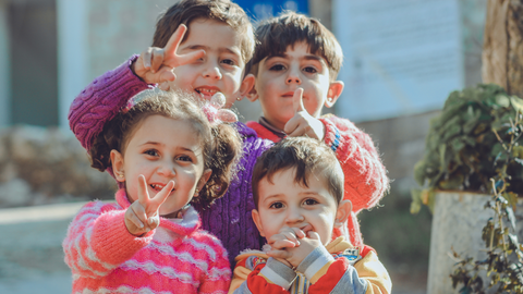 children are making different poses for the picture