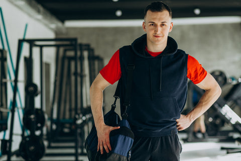 Young handsome man in sportswear at the gym