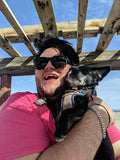 Billy of BillysBassoonReeds holding Albert on the beach of Bombay Beach in California 