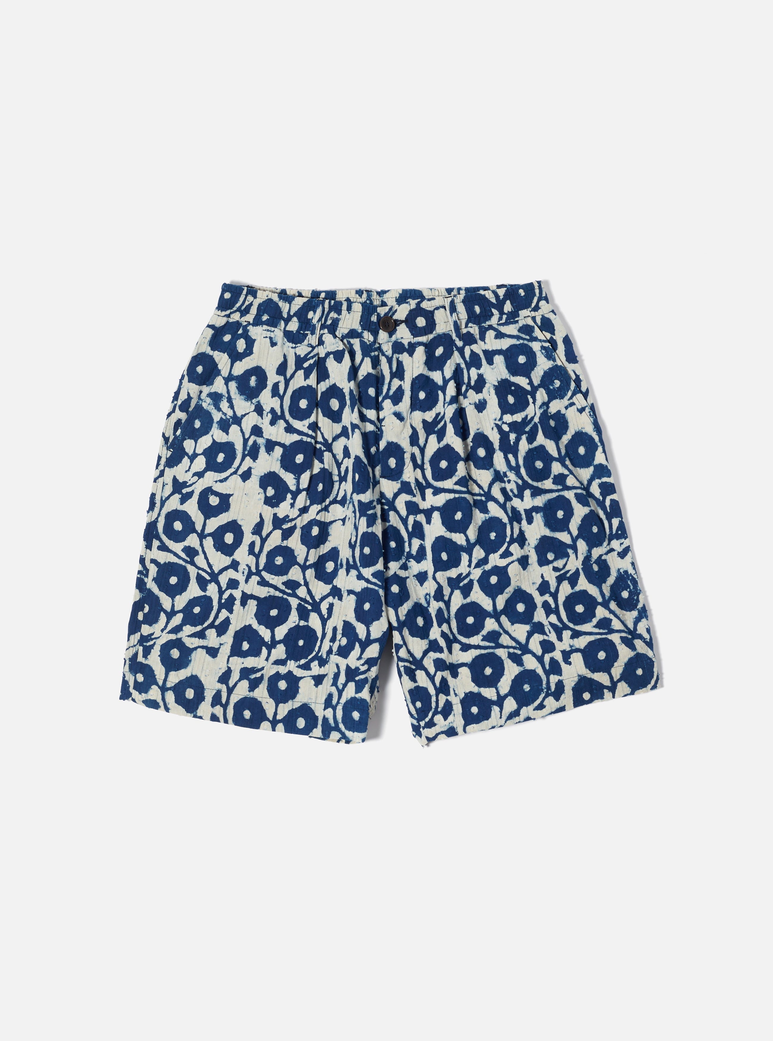 The 'Pleated Track Short' is a super-loose but smart-looking short with an elasticated waist and pleated front. A unique jacquard textured cotton cloth, hand-finished with block-printed indigo flower patterns. Fabric Content: 100% Cotton.