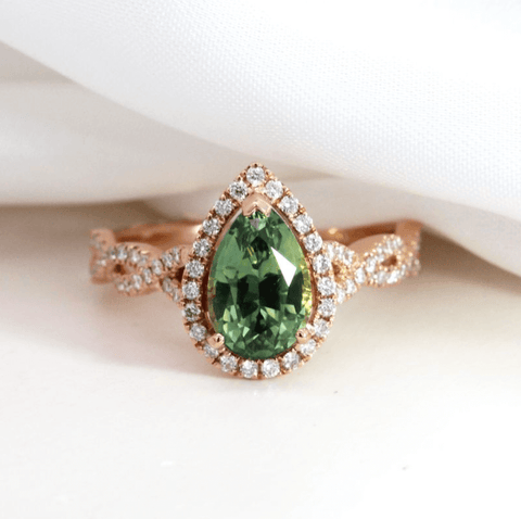 green sapphire halo engagement ring twisted band rose gold