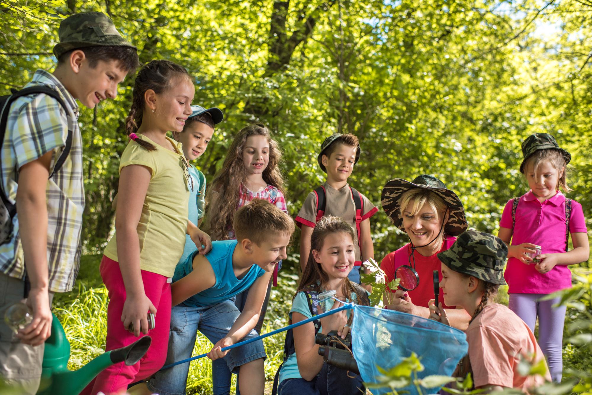 Large group of children on a field trip with teacher