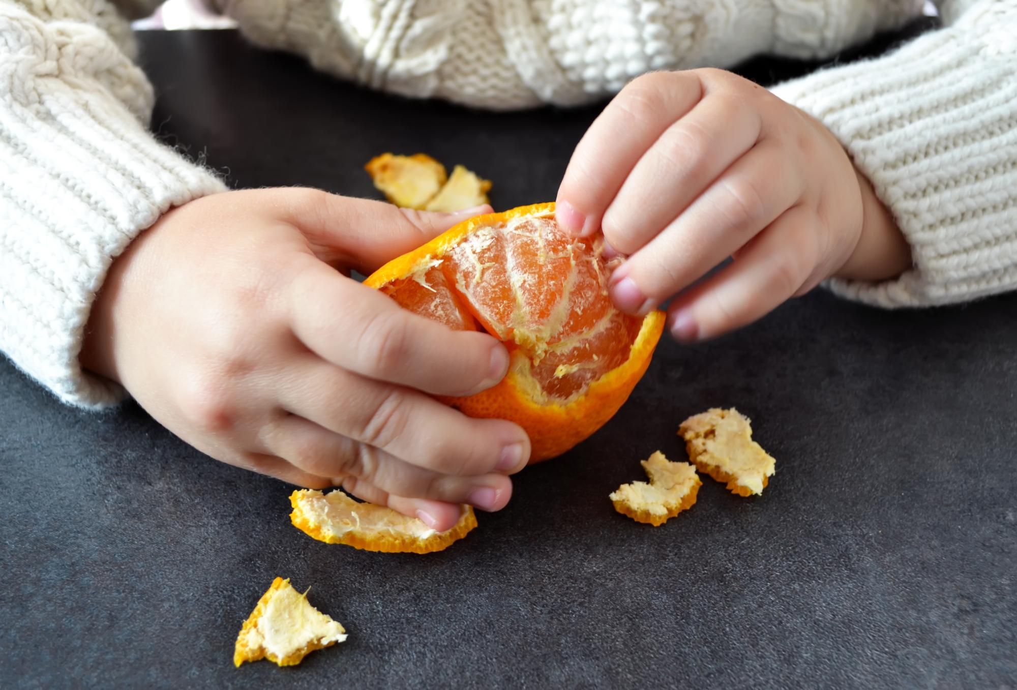 In the hands of the child's Mandarin.