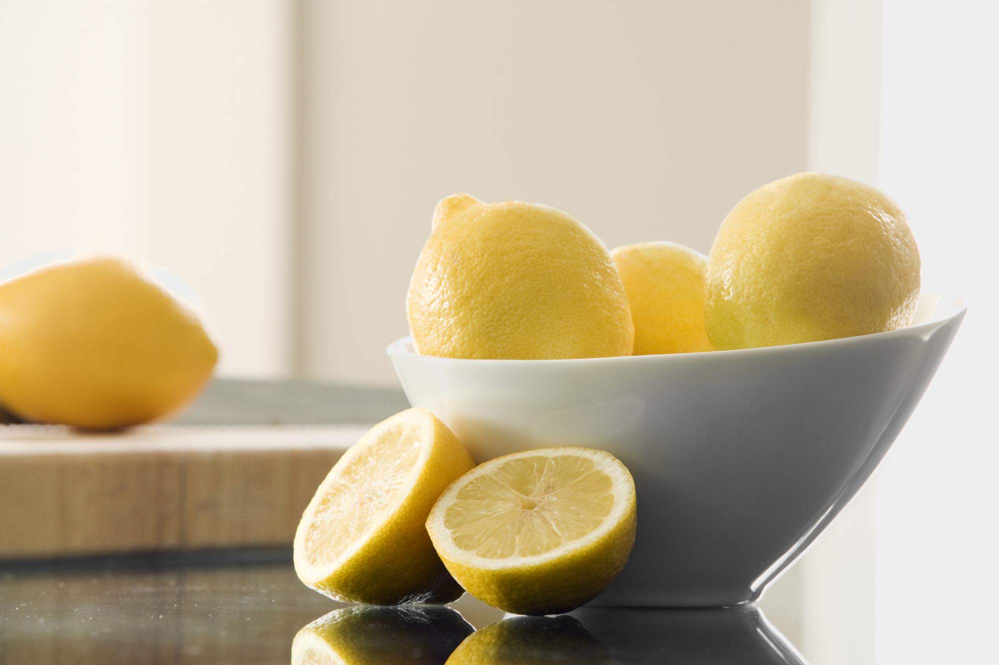 Lemons in a bowl and cut up on counter