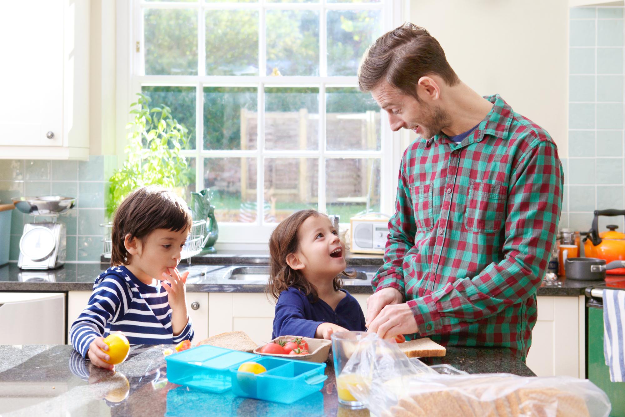 little brothers with father making lunch