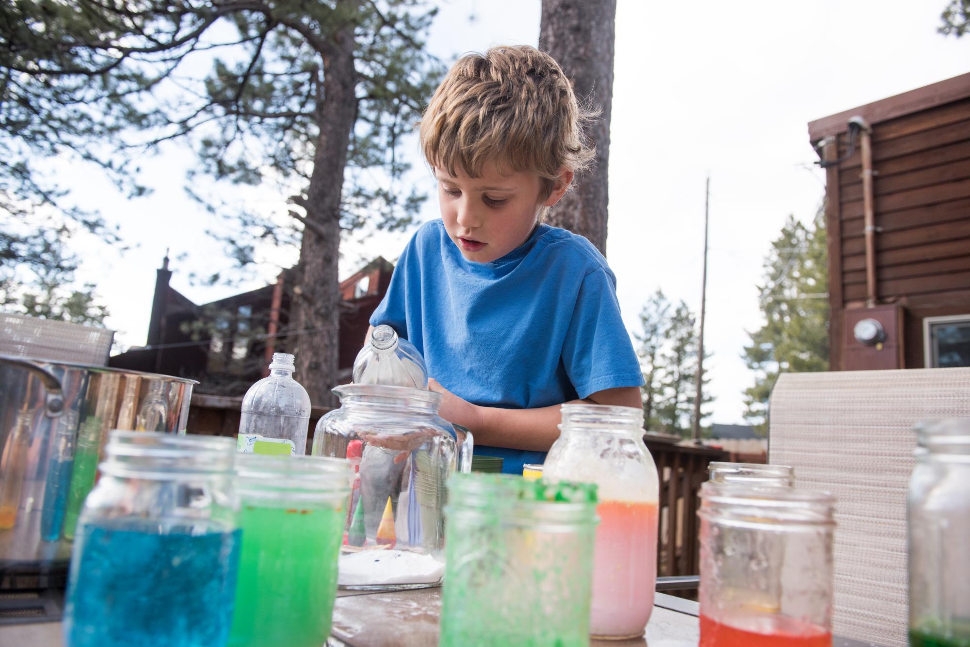 kid doing science project outdoors