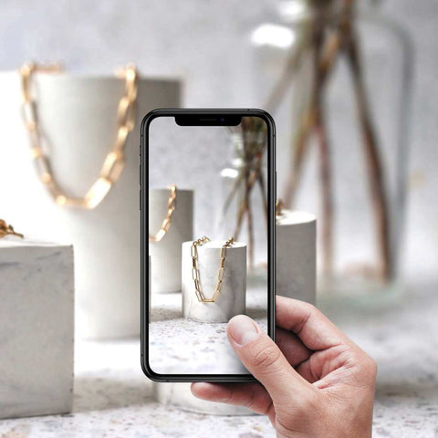 taking product photography image with phone in hand