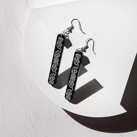 using small props to support earrings in product photo