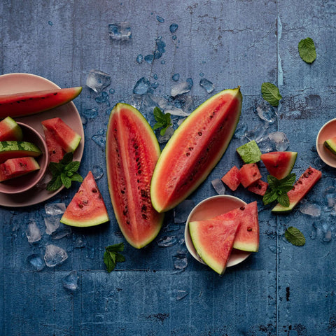 cut watermelon on a deep blue backdrop by CM Props & Backdrops