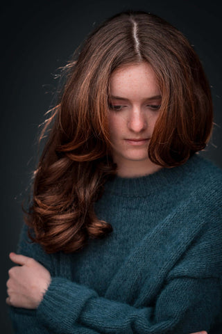 portrait of teen, looking down using grey backdrop