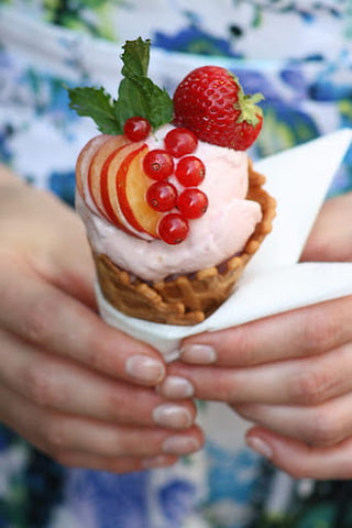 Strawberry ice cream in a cone