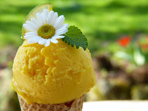 Lemon ice cream in a cone with flower on top