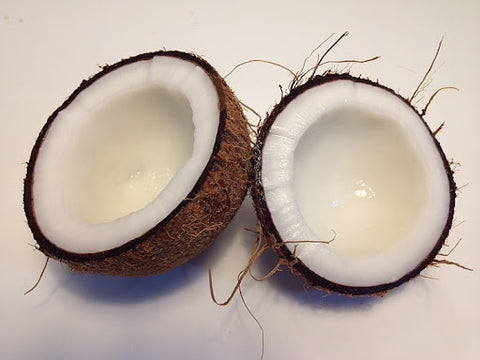 Two halves of a coconut next to each other