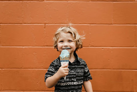 A boy eating vegan ice cream in a cone