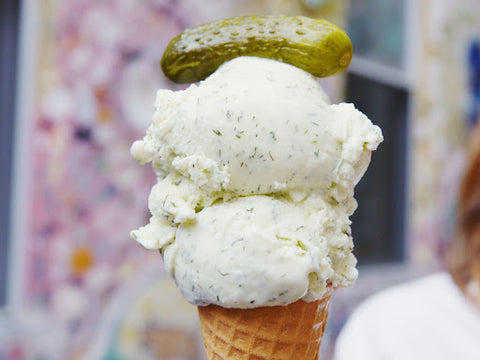 Pickled ice cream with pickle topping in a cone