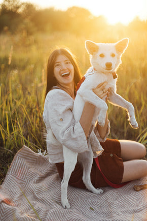 stylish-happy-woman-playing-with-her-white-dog-on-2023-11-27-05-22-34-utc 2.jpg__PID:ccec3ae2-f5bb-4064-85a4-e08096e3e830