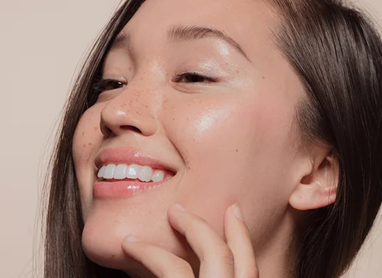 Image of model with clear, shiny, and healthy skin, radiating a natural glow