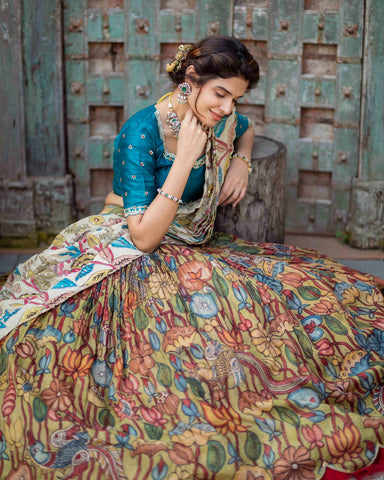 Elegant Peacock Blue Kalamkari Silk Lehenga with intricate hand-painted designs featuring nature and mythology motifs, showcasing vibrant hues and exquisite craftsmanship.