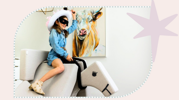 play couch made into a horse with young girl dressed as cowgirl