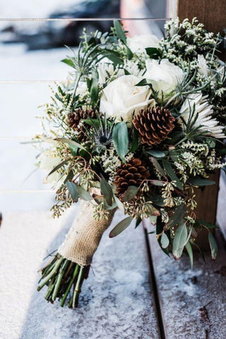 winter wedding bouquet with pinecone and greenery