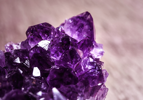 Beautiful Purple Amethyst Gemstone on Blurred Brown Background