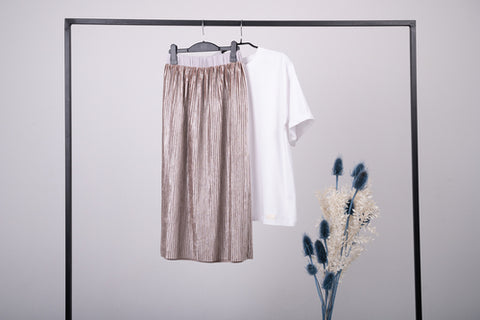 Capsule wardrobe showing a midi skirt and white t-shirt