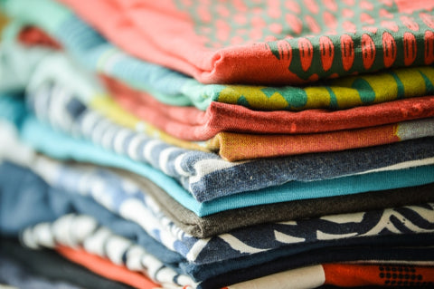 Pile of folded graphic t-shirts