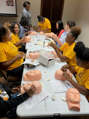 Funeral service camp participants learning about restorative arts