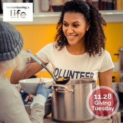 11.28 Giving Tuesday. Image of woman wearing a "Volunteer" tshirt serving soup to another person