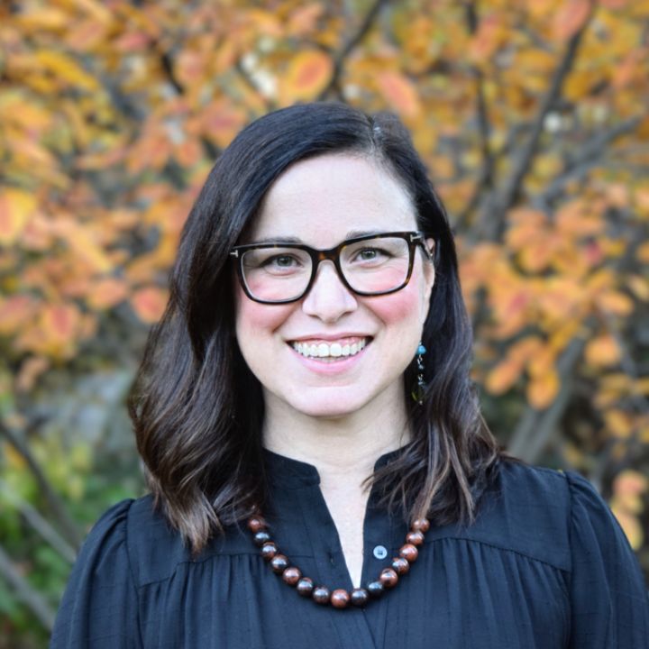 Shannon Donnick standing in front of colorful, fall trees