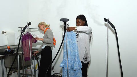Workers steaming clothes at Fashion Week via Ben Gabbe/Getty Images