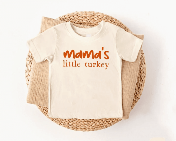 A Thanksgiving shirt with a caption that reads Mama's little turkey