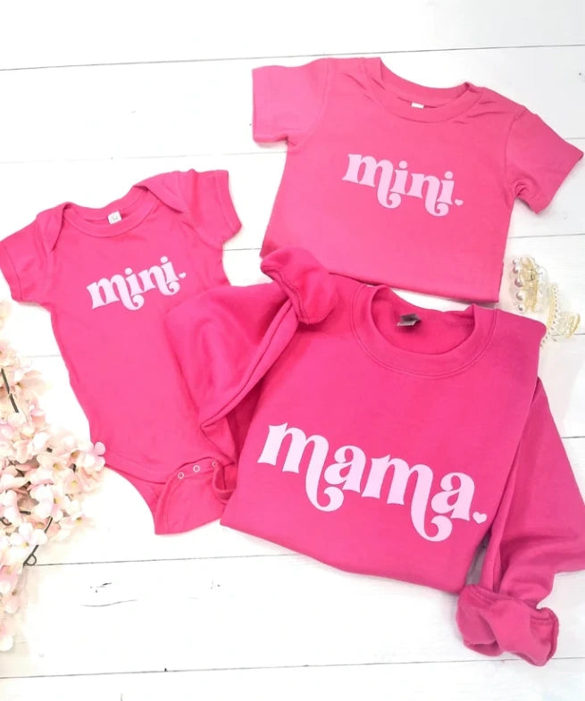Family matching shirts in hot pink for mama, little girl, and baby
