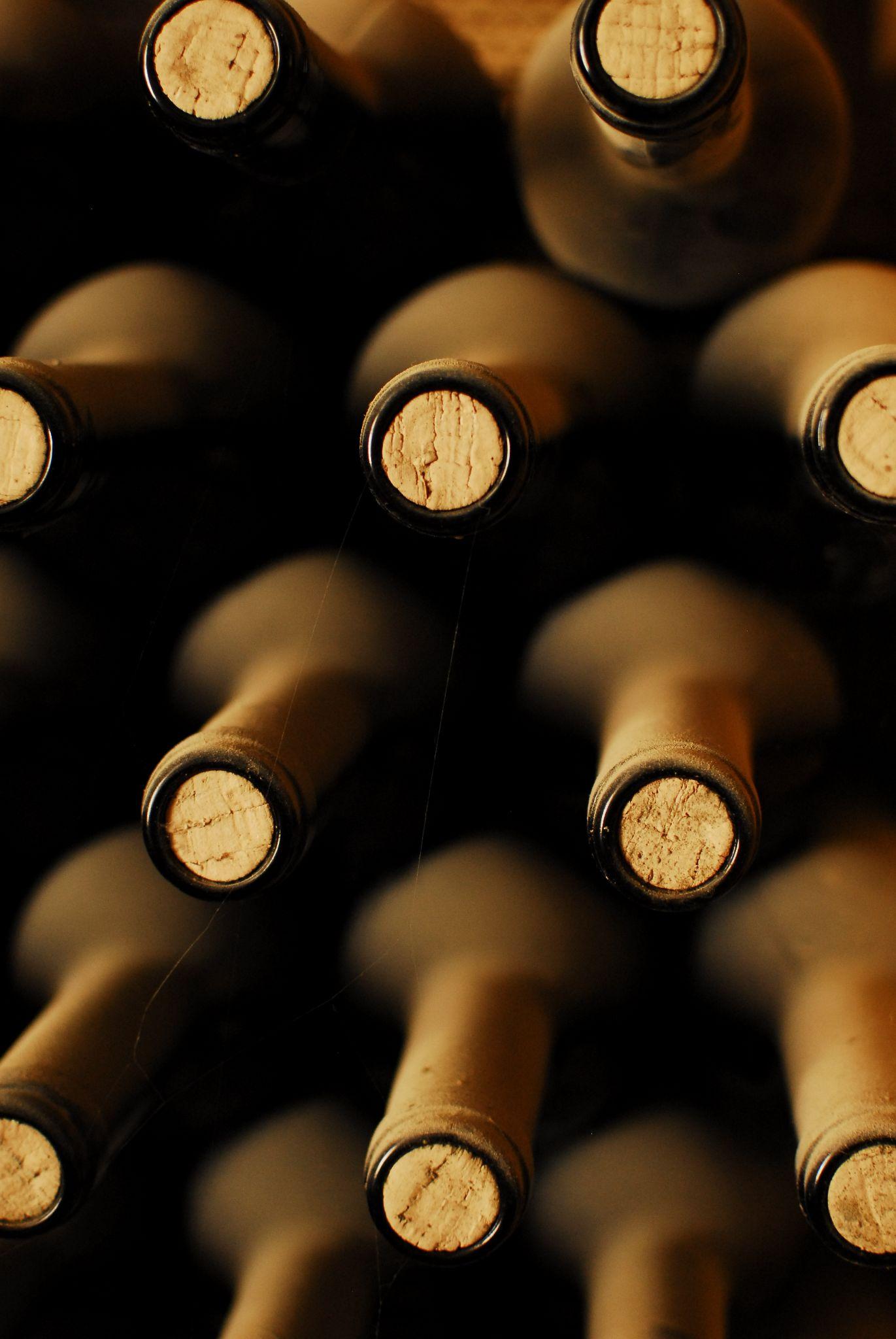 stacked up wine bottles in the cellar