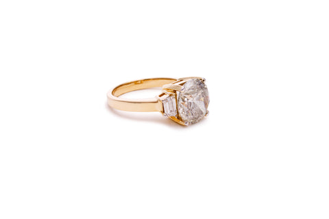 vintage style lab grown round diamond with baguette side stones and a yellow gold band