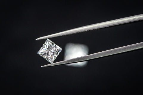 lab grown princess cut diamond in tweezers