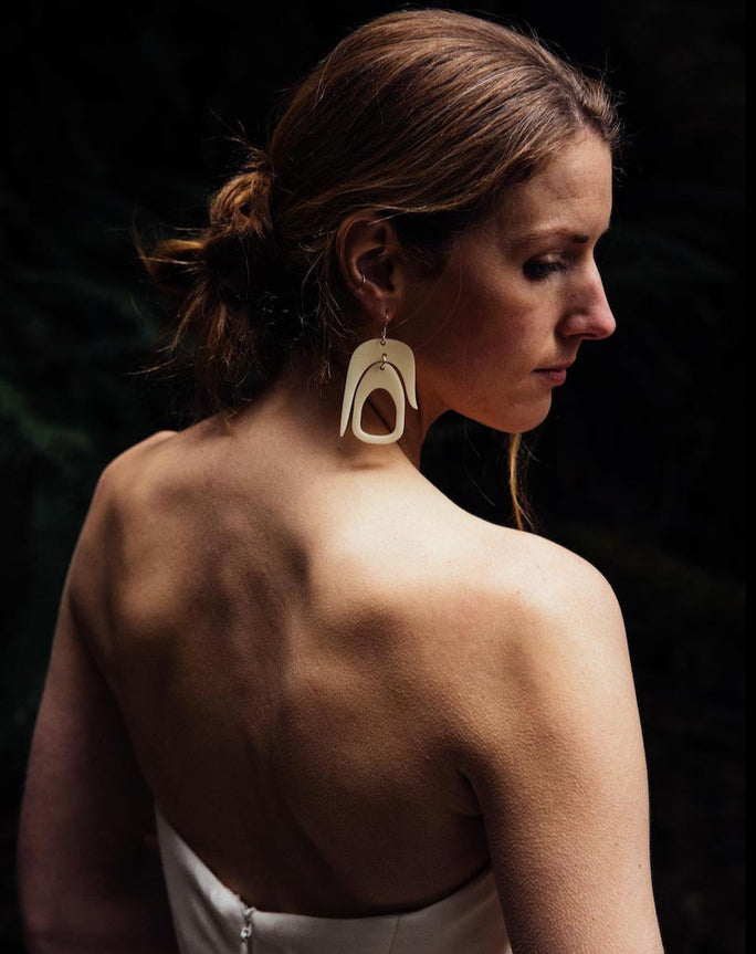 a bride in white earrings by Warren Steven Scott