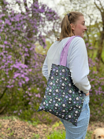 panda tote bag, ideal for a panda lover, shown on model in the park