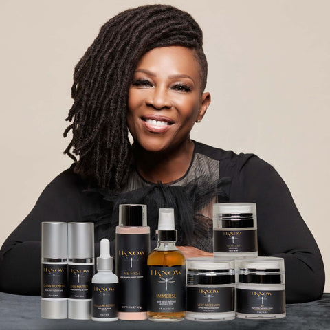 Black Woman sitting in front of skincare